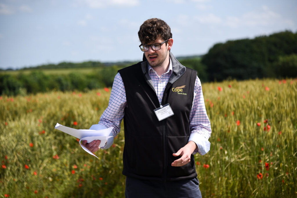 Taylor Moore stood speaking in the fields|The diary of an assistant variety rep at Cope Seeds & Grain